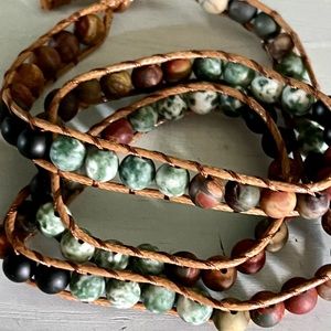 Natural stone multi layered bracelet with flower closure.